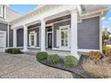 A spacious porch with stately columns enhances this home's curb appeal at 5960 Bolsena Place, Myrtle Beach, SC 29577