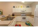 White kitchen with granite counters & appliances at 601 N Hillside Dr. # 3634, North Myrtle Beach, SC 29582