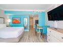 Bright condo bedroom and dining area with beach-themed decor, a flat screen TV, and a kitchenette at 7200 N Ocean Blvd. # 314, Myrtle Beach, SC 29572
