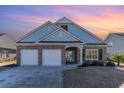Brick home with a two-car garage and a landscaped front yard at 92 Preservation Dr., Myrtle Beach, SC 29572