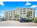 Close-up of Sands Beach Club condos in Myrtle Beach, South Carolina, surrounded by lush landscaping at 9400 Shore Dr. # 311, Myrtle Beach, SC 29572