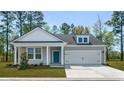 Beautiful single-story home with stylish gray siding, a front porch, and an attached two-car garage at 123 Tbd Sun Colony Blvd., Longs, SC 29568
