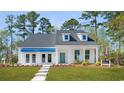 Beautiful two-story home with a covered porch and well-maintained front lawn at 124 Tbd Sun Colony Blvd., Longs, SC 29568