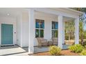 Inviting front porch features comfortable seating and stylish decor at 124 Tbd Sun Colony Blvd., Longs, SC 29568