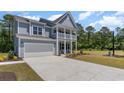 Two-story house with gray siding, white trim, and a large driveway at 1828 Hardwood Ct., Conway, SC 29526
