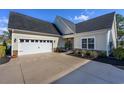 Spacious two-car garage with an extra-wide driveway and manicured landscaping at 1829 Wood Stork Dr., Conway, SC 29526