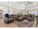 Open living space with a comfortable sectional sofa and large windows at 1853 Wood Stork Dr., Conway, SC 29526
