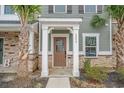 Inviting home entrance with stone accents, decorative columns, and a stylish front door with glass insert at 200 Yam Dr. # D, Myrtle Beach, SC 29579