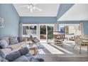 Bright living room with sliding doors to deck and ocean views at 203 Heron Marsh Dr. # 78, Pawleys Island, SC 29585