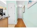 Hallway with hardwood floors and light-mint walls at 212-C Landing Rd. # 212-C, North Myrtle Beach, SC 29582