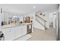 Open kitchen area with granite island, stainless steel dishwasher, and staircase leading to upper level at 2602 Blue Crane Circle # 101, Myrtle Beach, SC 29577