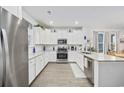 Bright kitchen featuring white cabinets, granite countertops, stainless steel appliances and modern finishes at 2602 Blue Crane Circle # 101, Myrtle Beach, SC 29577