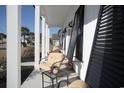 Relaxing front porch with rocking chairs, black shutters, and white columns at 261 Marsh Tacky Loop, Myrtle Beach, SC 29588