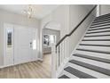 Inviting entryway features wood floors, stairs with a dark wood banister, and arched doorways at 336 Happy Valley Dr., Myrtle Beach, SC 29588