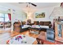 Living room with hardwood floors, brown sofas, and partial dining room view at 3657 Highway 472, Conway, SC 29526