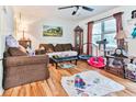 Living room with hardwood floors, brown sofas, and Gathering toys at 3657 Highway 472, Conway, SC 29526