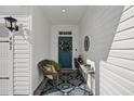 Front entry with blue door, wreath, bench, and patterned rug at 403 Mikita Dr., Surfside Beach, SC 29575