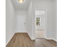 Hallway with hardwood flooring leads to a bedroom; natural light, bright and airy at 409 Sun Colony Blvd., Longs, SC 29568