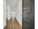 Bright hallway with wood flooring, leading to other rooms in the house at 409 Sun Colony Blvd., Longs, SC 29568