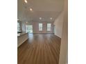 Open living room and kitchen area with recessed lighting and sliding glass doors to the patio at 409 Sun Colony Blvd., Longs, SC 29568