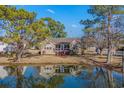 Charming home backing onto a serene pond, offering tranquil views and a screened-in porch at 4110 Fairway Dr., Little River, SC 29566