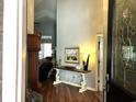 Inviting entryway with wood floors, decorative accents, and a glimpse into the living area with high ceilings at 414 Grand Cypress Way, Murrells Inlet, SC 29576