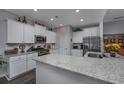 Modern kitchen with white cabinets, granite countertops, and stainless steel appliances at 440 Craigflower Ct., Longs, SC 29568