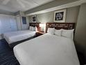 Two double beds, television, and nightstands in a well-lit room at 5300 N Ocean Blvd. # 1005, Myrtle Beach, SC 29577
