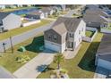 Two-story house with gray siding, a white garage door, and a landscaped lawn at 536 Affinity Dr., Myrtle Beach, SC 29588