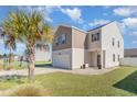 Two-story house with gray and beige siding, a white garage door, and a landscaped lawn at 536 Affinity Dr., Myrtle Beach, SC 29588