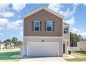 Two-story house with gray siding, a white garage door, and a landscaped lawn at 536 Affinity Dr., Myrtle Beach, SC 29588