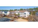 Charming multi-level condo building with lovely balconies, lush landscaping, and a relaxed ambiance at 5825 Catalina Dr. # 332, North Myrtle Beach, SC 29582