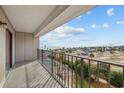 Spacious balcony featuring metal railings with views of the beach and clear blue skies at 5905 S Kings Hwy. # 312-C, Myrtle Beach, SC 29575