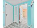 Bright entryway with light grey wood-look floors and light teal walls at 5905 S Kings Hwy. # 312-C, Myrtle Beach, SC 29575