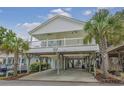 Front view of an elevated beach house with a porch at 6001-1830A S Kings Highway, Myrtle Beach, SC 29575