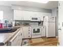 Bright kitchen boasts white cabinets, efficient layout, and modern appliances for easy meal preparation at 627 Waterway Village Dr. # 8-I, Myrtle Beach, SC 29579