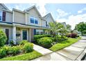 Close-up of townhome with colorful flowerbeds and a palm tree at 764 Wilshire Ln. # 764, Murrells Inlet, SC 29576