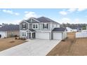 Charming two-story home with gray siding, black shutters, and a three-car garage at 1052 Kinness Dr., Conway, SC 29527