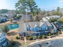 Beautiful aerial view of a townhouse complex with a pond and mature trees at 1061 Pinwheel Loop # 1061, Myrtle Beach, SC 29577