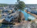 Stunning aerial view of townhouses by a serene pond with a fountain at 1061 Pinwheel Loop # 1061, Myrtle Beach, SC 29577