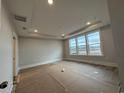 Bedroom with recessed lighting, tray ceiling, and large windows with a view at 1121 Oxeye St., North Myrtle Beach, SC 29582