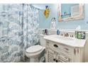 Bright bathroom with blue accents featuring a white vanity and coastal-themed decor at 116 Cypress Estates Dr., Murrells Inlet, SC 29576