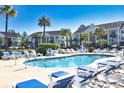 Community pool with lounge chairs and tropical landscaping around condo complex at 118 Birch N Coppice Dr. # 3, Surfside Beach, SC 29575