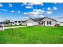 View of a well-manicured lawn with a single-story home with a grey exterior at 124 Blue Jacket Dr., Galivants Ferry, SC 29544