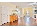 Bright and airy foyer featuring hardwood floors and a decorative table at 128 Belclare Way, Longs, SC 29568