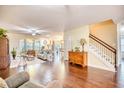 Open-concept living and dining area with hardwood floors, and ample natural light at 128 Belclare Way, Longs, SC 29568