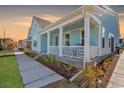 Charming front porch with white columns and landscaping at 130 Black Water Dr., Murrells Inlet, SC 29576