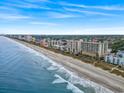 Breathtaking aerial view of the beach with multiple buildings and ocean waves at 1321 S Ocean Blvd. # 1101, North Myrtle Beach, SC 29582