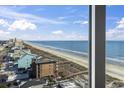 Scenic view from a window of the beach and ocean with blue skies at 1321 S Ocean Blvd. # 1101, North Myrtle Beach, SC 29582