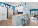 Bright kitchen features blue walls, granite counters, white cabinets and stainless steel appliances at 136 Birch N Coppice Dr. # 11, Surfside Beach, SC 29575